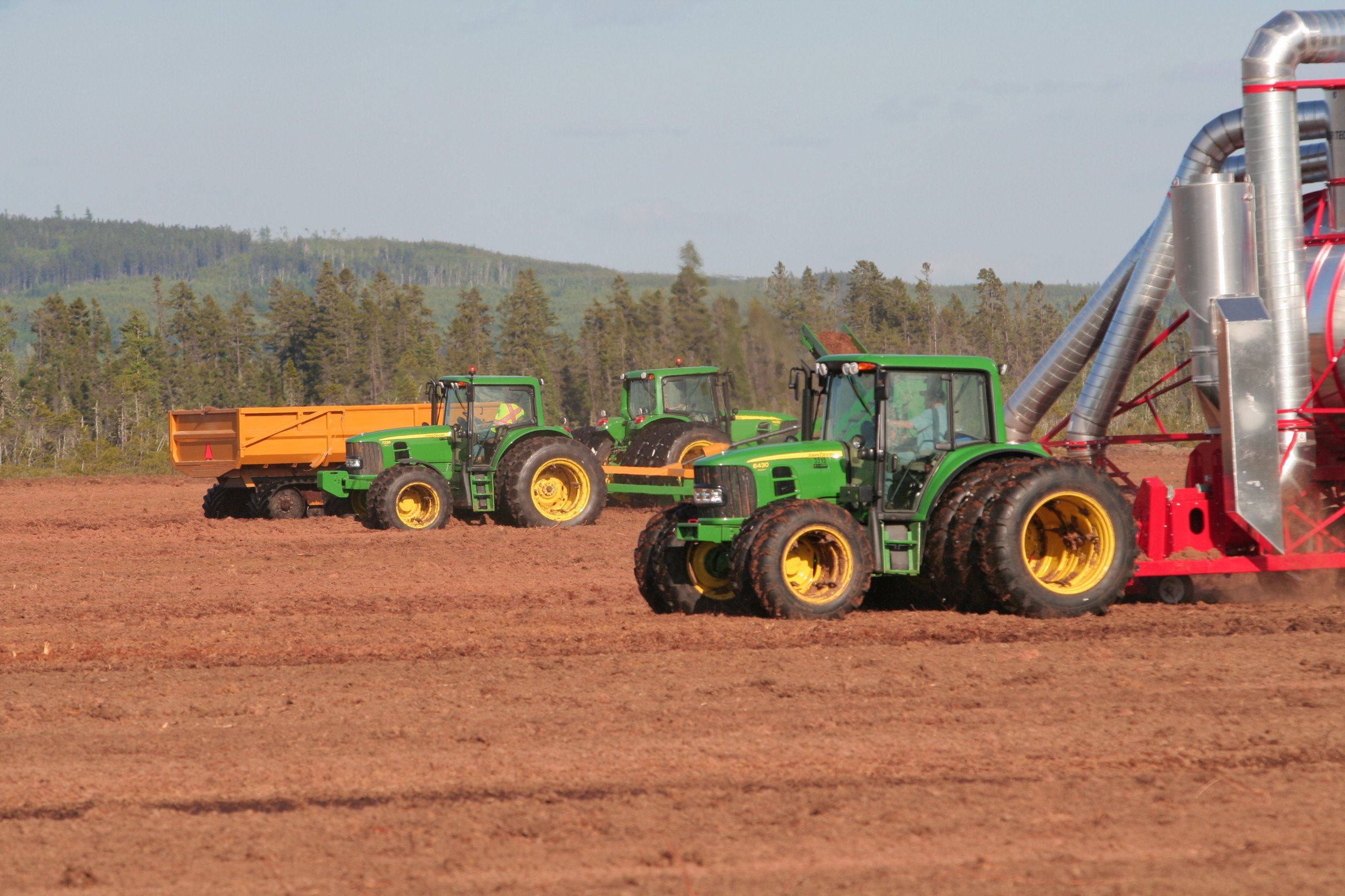 Machines collecting peat moss